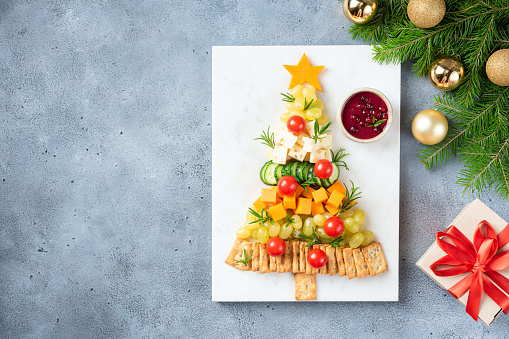 Seasonal Cheese Plate Shaped As Christmas Tree On Marble Board, Copy Space For Text or Design ELements