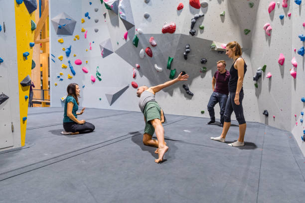 istock Indoor climbers stretching and preparing to climb a wall 1443462200