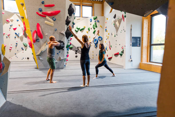 istock Indoor climbers stretching and preparing to climb a wall 1443462238