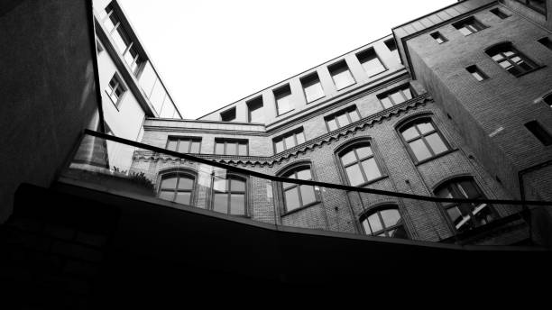 istock Grayscale of a building with many windows and clear sky 1443462976