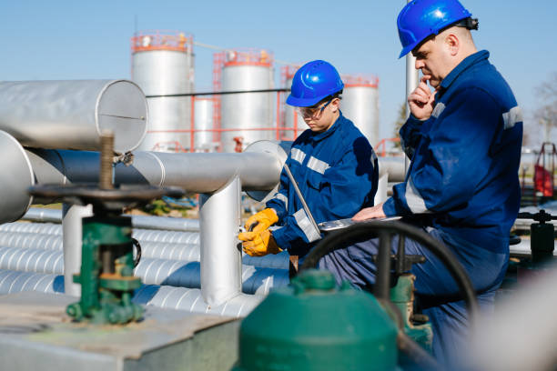 istock Two engineers working inside oil and gas refinery 1443464383