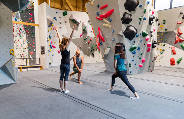 istock Indoor climbers stretching and preparing to climb a wall 1443464663