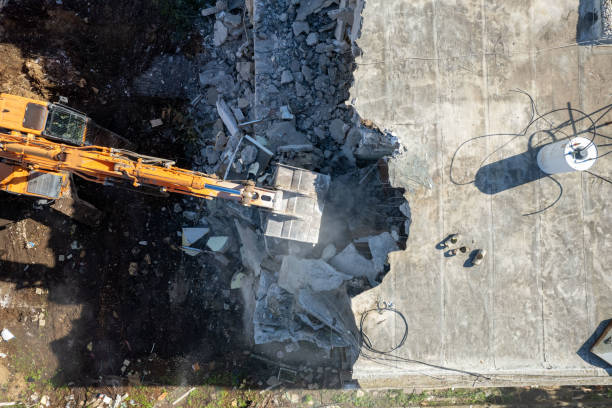 istock Excavator demolishing barracks for a new construction project. 1443464749