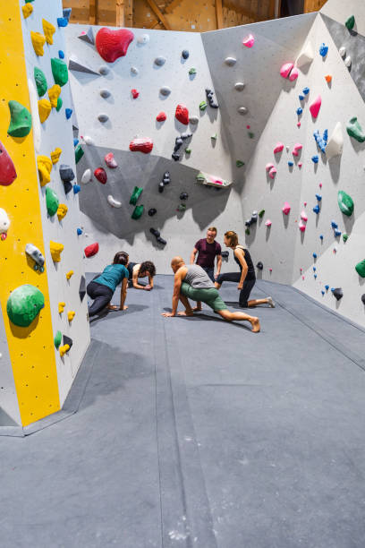 istock Indoor climbers stretching and preparing to climb a wall 1443464781
