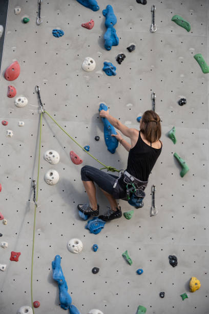 istock Female professional rock climber practicing at training center 1443464989