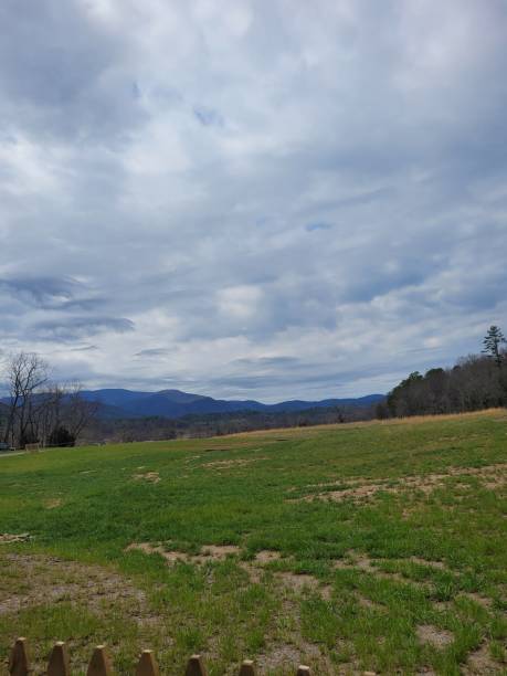 istock Shot of a field under a beautiful cloudy sky 1443464991