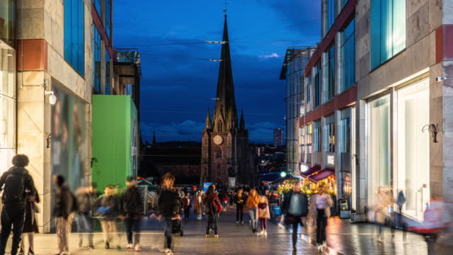 Time lapse of Birmingham St Martin church and Bull Ring Shopping Centre with crowd people and tourist walking in the city of Birmingham at night, West Midlands, England