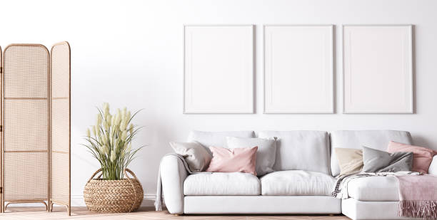 istock Poster frame mockup in modern living room design, bright interior with pink and white sofa on minimal background 1443465932
