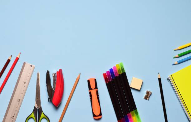 istock Assorted school supplies scattered on the blue background 1443466030