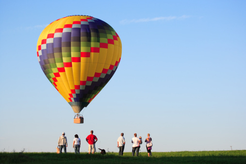 colorful hot air balloon landing with 6 spectators in foreground, , Canon 1Ds Mk II
