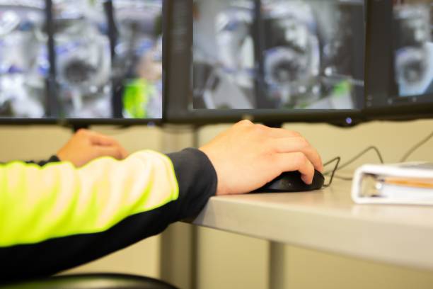 istock Male hand clicking the mouse while doing security monitoring, close-up 1443467924