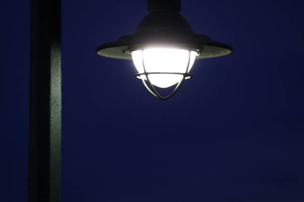 A street lamp glowing in the evening