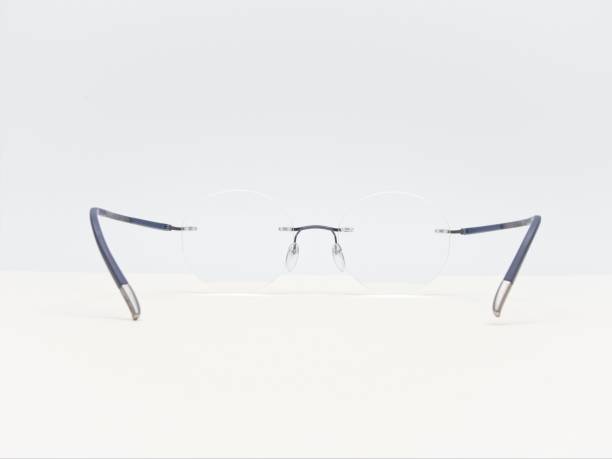istock pair of frame less glasses on a bright white desk 1443468432