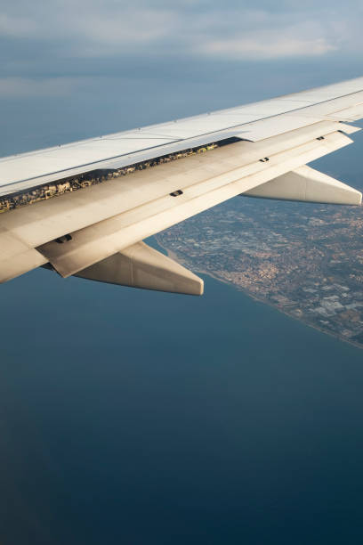 istock Flap wings opening on an aircraft wing while landing 1443468579