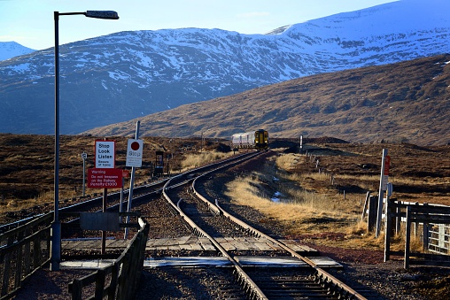 A Class 156 train approaches the remote Corrour Station, on Scotland's scenic West Highland Line