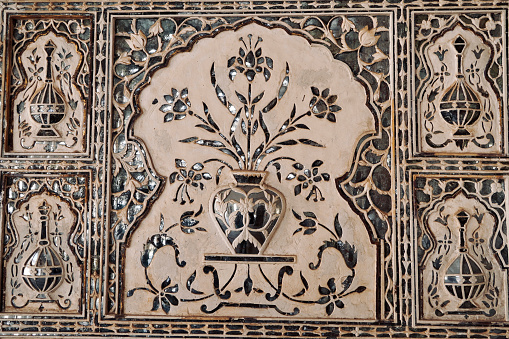 Floral designs carved in the wall of interior of Amber fort in Jaipur.