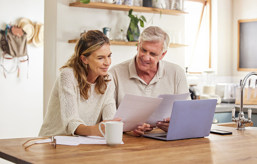 Retirement, finance and couple with budget on laptop satisfied with home expenses in New Zealand. Happy, positive and married senior people checking financial documents for investment payment.