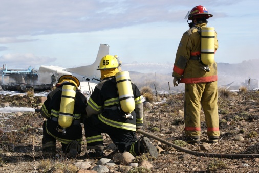 Fire fighters action on a plane fire during a drill in San Martin de los Andes, Neuquen Patagonia Argentina