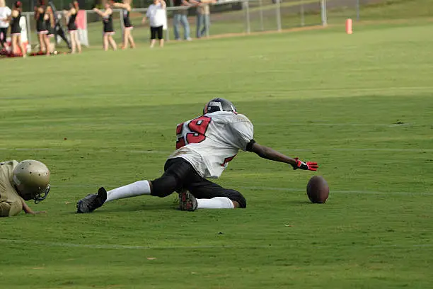 Jr High football game, Player drops ball, made rush to recover ball.