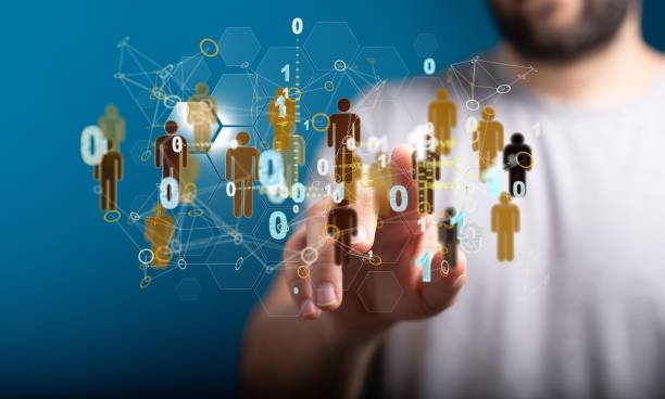 istock Man touching a web of illustrative 3D rendered user icons on a transparent screen in front of him 1443473972