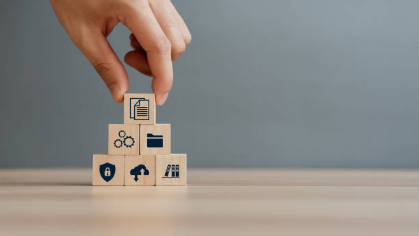 istock Hand putting document icon in the wooden cube for document management digital file data online records keeping, database technology, file access, and doc sharing. 1443474077