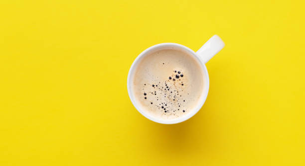 istock Espresso coffee on yellow background 1443474173