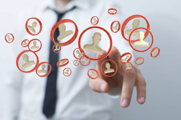 istock Out-of-focus man touching a 3D rendering of user icons 1443475193