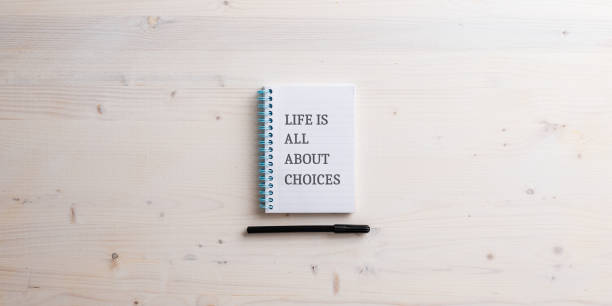istock Spiral notebook with a Life is all about choices sign written in it 1443475430