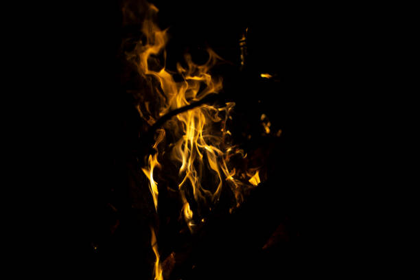 Flames in dark. Details of fire. Fire on black background. Process of ignition.