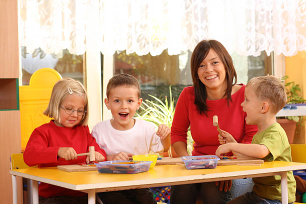 istock Cute preschoolers having fun class with teacher 144348036