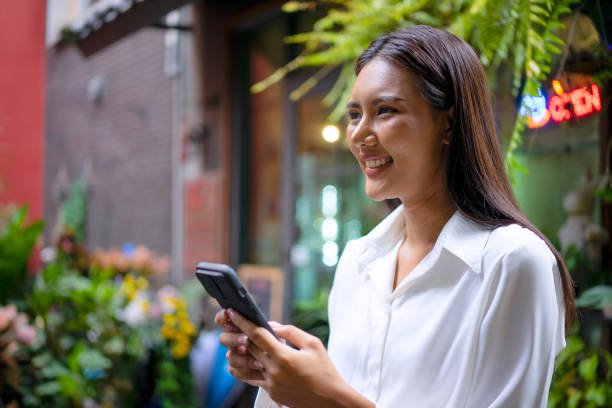 istock Young woman is using a digital device for electronic banking at public place. 1443482716