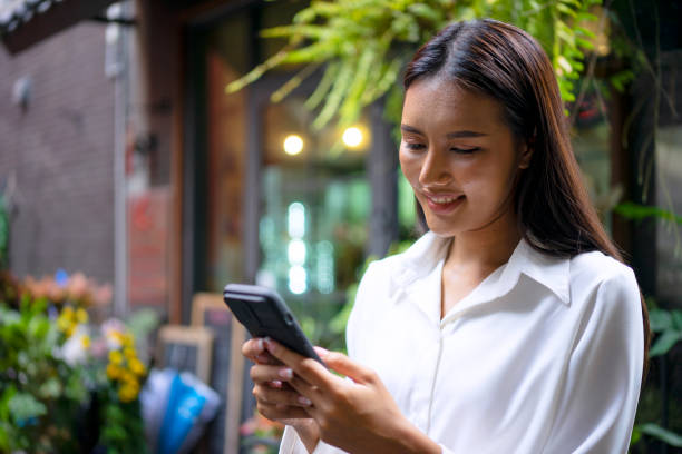 istock Young woman is using a digital device for electronic banking at public place. 1443482718