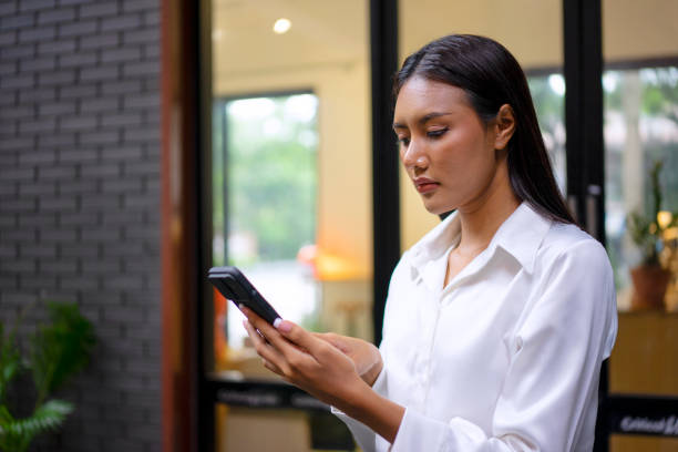 istock Young woman is using a digital device for electronic banking at public place. 1443482727
