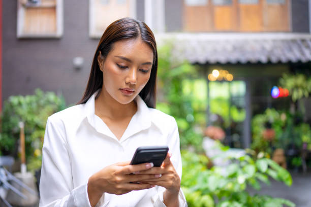 istock Young woman is using a digital device for electronic banking at public place. 1443482763