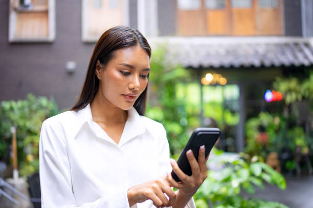 istock Young woman is using a digital device for electronic banking at public place. 1443482772