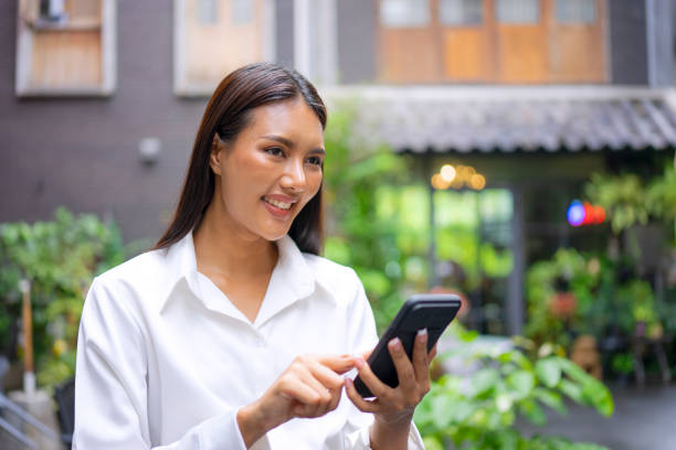 istock Young woman is using a digital device for electronic banking at public place. 1443482786