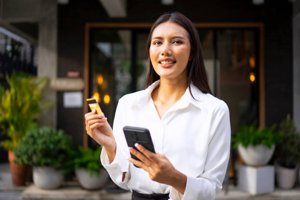 istock Young woman is using a digital device for electronic banking at public place. 1443482878