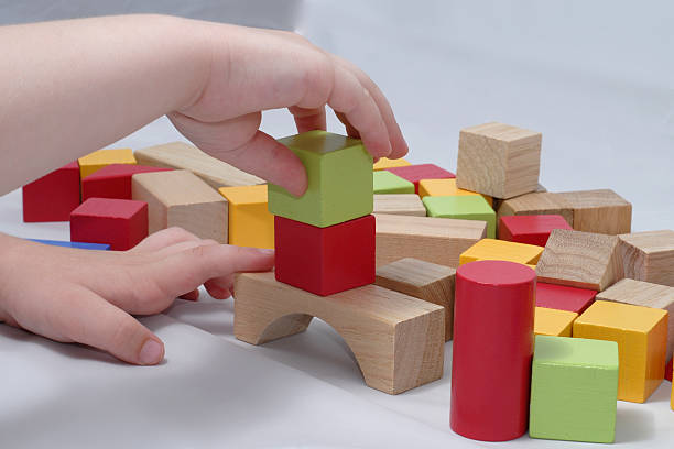 istock Child building with wooden blocks 144348573