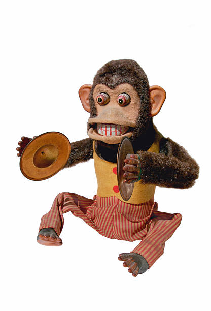 A mechanical chimp with cymbals on a white background
