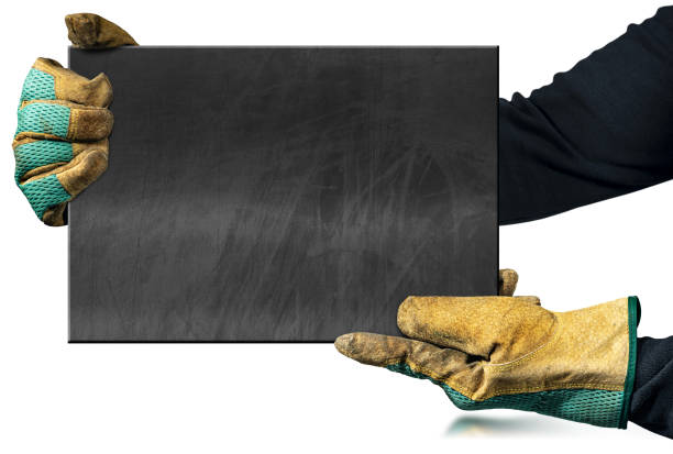Manual worker with protective work gloves holding a blank chalkboard with copy space, isolated on white background with reflections,