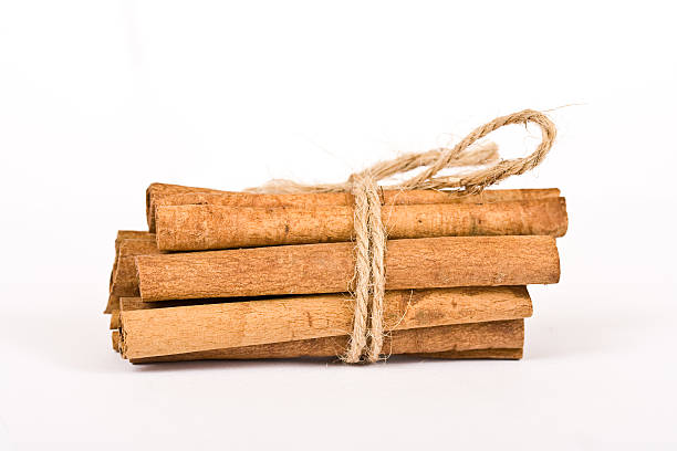 istock cinnamon spicy sticks close-up isolated over white 144348902