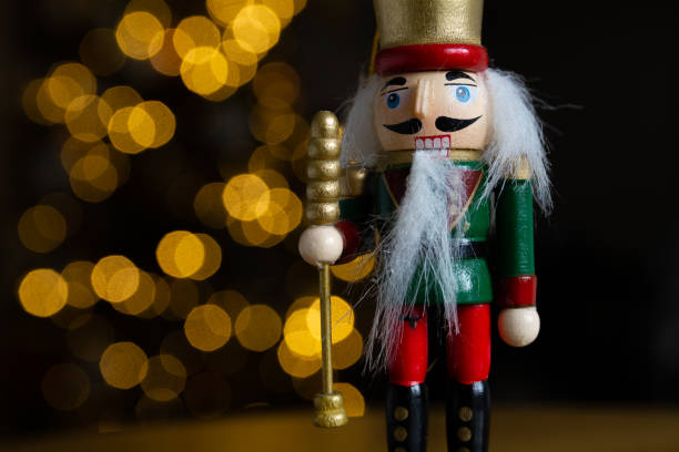 istock Christmas nutcracker wooden figure, toy soldier decoration with tree lights bokeh. 1443490921