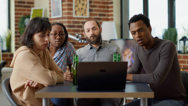 istock Millennial people watching online video on laptop together 1443491744
