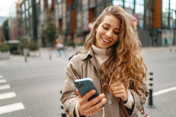 istock Young woman using mobile device standing in the city 1443493902