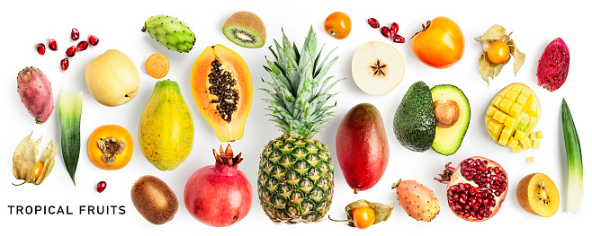 Different tropical fruits set. Papaya, pomegranate, kiwi, physalis, nashi, avocado, persimmon, pineapple, mango and pear fruit isolated on white background. Creative layout. Flat lay, top view