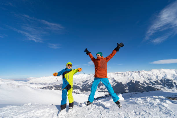Father and son enjoying ski holidays in mountains