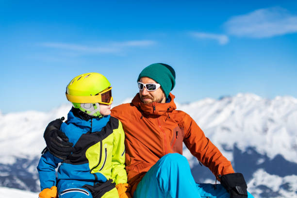 istock Father and son enjoying ski holidays in mountains 1443495677