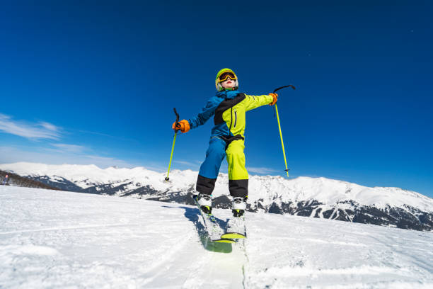 istock School age boy skiing in mountains at ski resort 1443495688