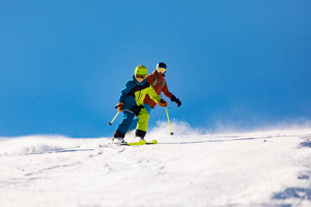 istock Father and son skiing and snowboarding in mountains 1443495771