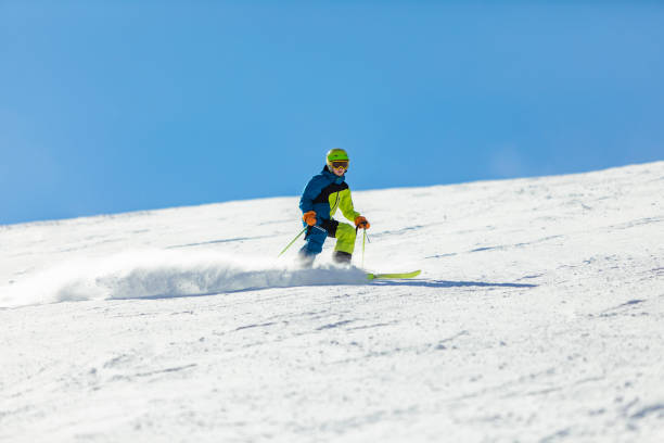 istock School age boy skiing in mountains at ski resort 1443495780